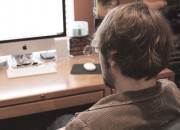 Page Lynch studying the iMac screen
